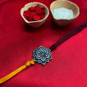 SIlver floral coin rakhi