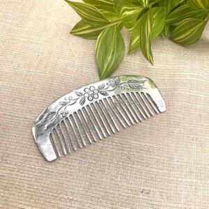 Silver comb with floral carving