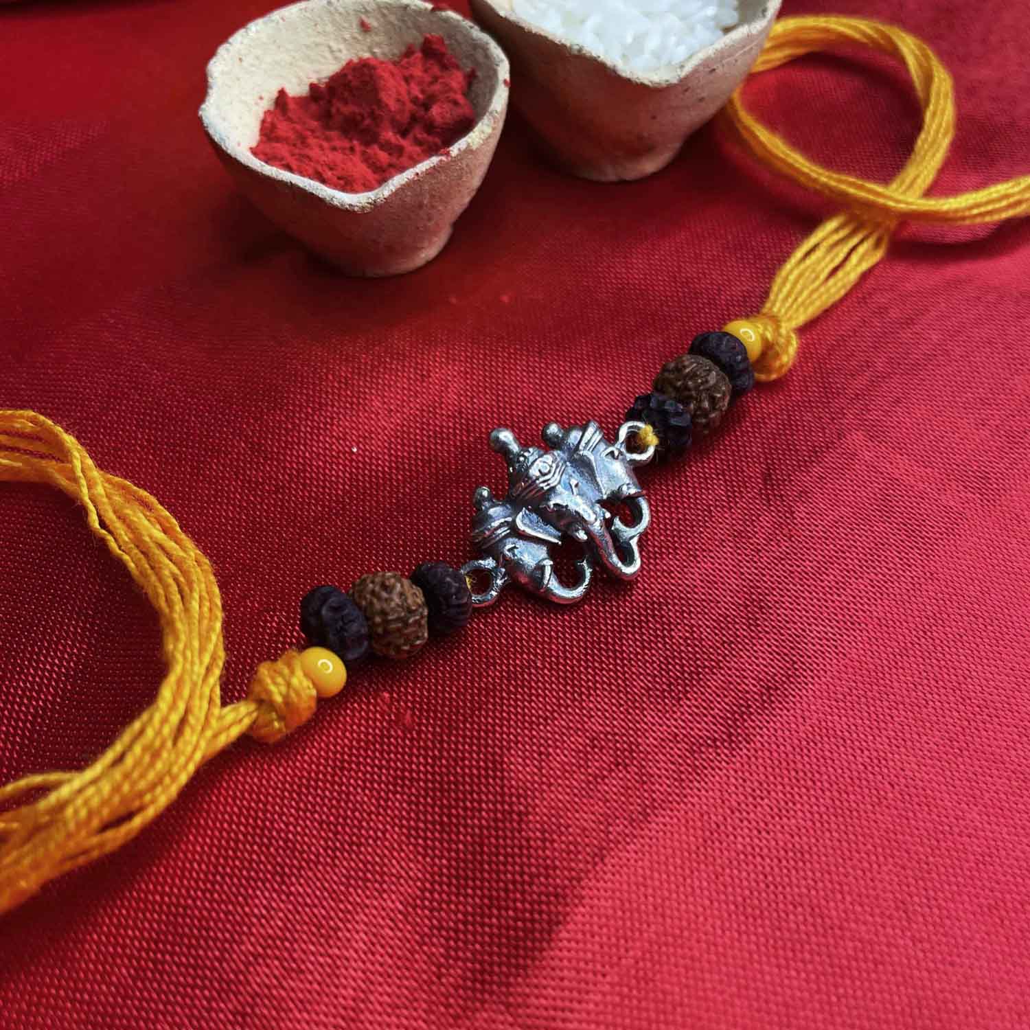 Silver trimukhi ganesha rakhi